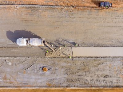 Concrete mix truck the pouring cement during to residential sidewalk workers at construction site